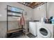 Basement laundry room with washer, dryer, utility sink, and a window for natural light at 10429 Quivas St, Northglenn, CO 80234