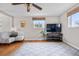 Bright living room with hardwood floors, neutral paint, large windows, ceiling fan, and great natural light at 10429 Quivas St, Northglenn, CO 80234