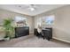 Bright home office area with carpet flooring, two windows for natural light, and functional furniture at 10429 Quivas St, Northglenn, CO 80234