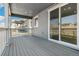 Covered back porch includes sliding glass door access and wood flooring for easy outdoor relaxation at 1871 Water Birch Way, Castle Rock, CO 80108