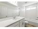 Bright bathroom features an extended vanity with a large mirror and a shower over the tub at 1871 Water Birch Way, Castle Rock, CO 80108