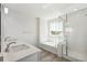 Bright bathroom with a double vanity, soaking tub, and glass-enclosed shower at 1871 Water Birch Way, Castle Rock, CO 80108