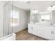 Bright bathroom featuring double sinks, modern fixtures, and a large glass shower enclosure at 1871 Water Birch Way, Castle Rock, CO 80108