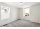 A well-lit bedroom with neutral carpet and two windows that let in plenty of natural light at 1871 Water Birch Way, Castle Rock, CO 80108