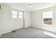 Bright bedroom with three large windows providing abundant natural light and comfortable carpeting at 1871 Water Birch Way, Castle Rock, CO 80108