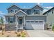 Charming two-story home with a two-car garage and beautifully landscaped front yard at 1871 Water Birch Way, Castle Rock, CO 80108