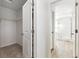 Hallway with closet and bathroom featuring modern tile and glass shower enclosure at 1871 Water Birch Way, Castle Rock, CO 80108