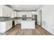 Well-lit kitchen with white cabinetry, stainless appliances, and a center island at 1871 Water Birch Way, Castle Rock, CO 80108