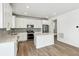 A modern kitchen featuring white cabinets, stainless steel appliances, and a central island at 1871 Water Birch Way, Castle Rock, CO 80108