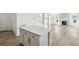 Open-concept layout featuring an island connecting kitchen to the well-lit living area with a fireplace at 1871 Water Birch Way, Castle Rock, CO 80108