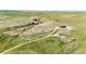 Scenic aerial view of a home on vast acreage featuring a winding dirt road and natural rock formations at 2710 Rustlers Canyon Loop, Elizabeth, CO 80107