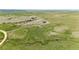 Expansive aerial view of a lush green acreage with natural rock formations and distant mountain views at 2710 Rustlers Canyon Loop, Elizabeth, CO 80107