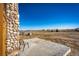 Backyard patio with serene views and a unique stone accent on the home's exterior at 2710 Rustlers Canyon Loop, Elizabeth, CO 80107