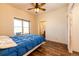 Bedroom features wood floors, a large window, and blue comforter at 2710 Rustlers Canyon Loop, Elizabeth, CO 80107