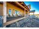 Inviting covered porch with seating, perfect for enjoying the outdoors and the view at 2710 Rustlers Canyon Loop, Elizabeth, CO 80107