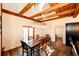 Charming dining room with wooden beams, hardwood floors, and a table that seats six, exuding rustic elegance at 2710 Rustlers Canyon Loop, Elizabeth, CO 80107