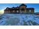 Spacious brown home featuring a stone foundation and welcoming front porch at 2710 Rustlers Canyon Loop, Elizabeth, CO 80107