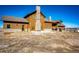 Charming home features a stone chimney, and wood exterior, set on a grassy plot at 2710 Rustlers Canyon Loop, Elizabeth, CO 80107