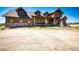 Beautifully crafted exterior with stone accents and a covered porch, showcasing rustic charm and inviting curb appeal at 2710 Rustlers Canyon Loop, Elizabeth, CO 80107