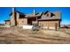 Spacious home with a stone chimney, wood siding, and a yard at 2710 Rustlers Canyon Loop, Elizabeth, CO 80107