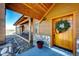 Charming entryway with a wooden door adorned with a festive wreath and stonework at 2710 Rustlers Canyon Loop, Elizabeth, CO 80107