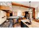 Modern kitchen features stone accents, stainless steel appliances, and a central island with a copper sink at 2710 Rustlers Canyon Loop, Elizabeth, CO 80107