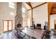 Spacious living room with vaulted ceilings, a stone fireplace, hardwood floors, and lots of natural light at 2710 Rustlers Canyon Loop, Elizabeth, CO 80107
