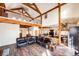 Spacious living area with exposed beams, a loft, and open to the kitchen and dining area at 2710 Rustlers Canyon Loop, Elizabeth, CO 80107