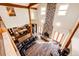 Spacious living room with hardwood floors, stone fireplace, and open kitchen with granite counters at 2710 Rustlers Canyon Loop, Elizabeth, CO 80107