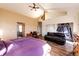 Spacious primary bedroom with wood floors, vaulted ceilings, closet space, and a seating area at 2710 Rustlers Canyon Loop, Elizabeth, CO 80107