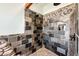 Custom shower with stonework, river rock base, and unique tree design at 2710 Rustlers Canyon Loop, Elizabeth, CO 80107