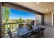 Covered balcony with an outdoor table and chairs overlooking scenic neighborhood views at 16549 Prospect Ln, Broomfield, CO 80023