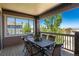 Covered balcony with an outdoor table and chairs overlooking picturesque views at 16549 Prospect Ln, Broomfield, CO 80023