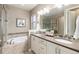 Relaxing bathroom features a soaking tub, a double vanity, and neutral decor at 16549 Prospect Ln, Broomfield, CO 80023