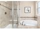 Modern bathroom features a shower and bathtub combo with decorative tiles and a glass door at 16549 Prospect Ln, Broomfield, CO 80023