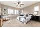 Bright bedroom featuring three large windows, ceiling fan, and neutral decor at 16549 Prospect Ln, Broomfield, CO 80023