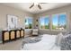 Bright bedroom with three windows offering neighborhood views, alongside stylish furnishings and decor at 16549 Prospect Ln, Broomfield, CO 80023