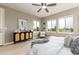 Bright bedroom features many windows, ceiling fan, and decorative furniture at 16549 Prospect Ln, Broomfield, CO 80023