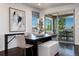 Dining room with modern decor features picture window and art, and flows out to a covered deck with mountain views at 16549 Prospect Ln, Broomfield, CO 80023