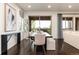 Elegant dining area with a dark wood table, comfortable seating, and sliding glass doors to an outdoor patio at 16549 Prospect Ln, Broomfield, CO 80023