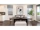 Dining room with modern decor, a dark wood table, an abstract art piece, and natural light from two windows at 16549 Prospect Ln, Broomfield, CO 80023
