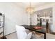 Open view of home office and kitchen space, featuring dark wood floors and modern lighting at 16549 Prospect Ln, Broomfield, CO 80023