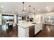 Bright kitchen with granite counters flows into a dining area and living room with a fireplace at 16549 Prospect Ln, Broomfield, CO 80023