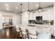 An open-concept kitchen with a large island, pendant lighting, and stainless steel appliances, adjacent to a cozy office at 16549 Prospect Ln, Broomfield, CO 80023