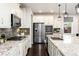 Modern kitchen with stainless steel appliances, granite countertops, and mosaic tile backsplash at 16549 Prospect Ln, Broomfield, CO 80023
