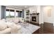 Comfortable living room with a sofa, chairs, a fireplace with mantel, and lots of natural light from large windows at 16549 Prospect Ln, Broomfield, CO 80023