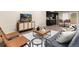 Open living space with modern furniture, a TV, and kitchenette featuring stainless steel appliances, offering comfort and convenience at 16549 Prospect Ln, Broomfield, CO 80023