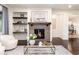 Bright living room featuring a cozy fireplace, decorative shelving, and stylish furnishings for a relaxing space at 16549 Prospect Ln, Broomfield, CO 80023