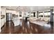 Open concept living space with hardwood floors, a modern kitchen, and a cozy sitting area at 16549 Prospect Ln, Broomfield, CO 80023