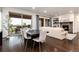 Open-concept living space with a dining area, living room featuring a fireplace, and access to an outdoor patio at 16549 Prospect Ln, Broomfield, CO 80023